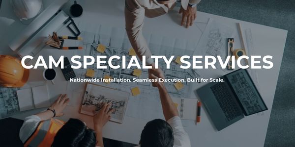 Team collaborating over blueprints with handshake, symbolizing partnership and execution.