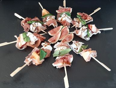 A selection of skewers with Parma Ham, torn mozzarella, basil and fig, melon or peach with a balsami