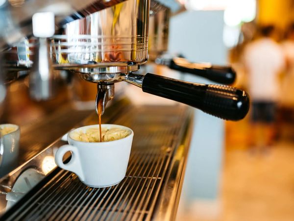 Espresso pouring into a white cup