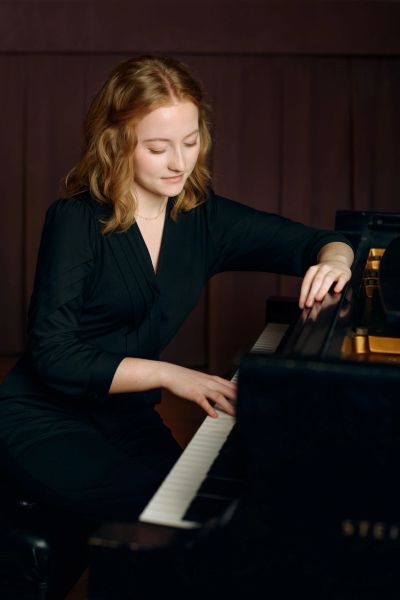 Woman playing piano with focus.