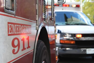 Close-up of emergency vehicles with 911 signs and flashing lights.