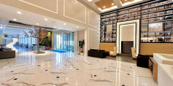 Spacious modern lobby with elegant decor and marble flooring.