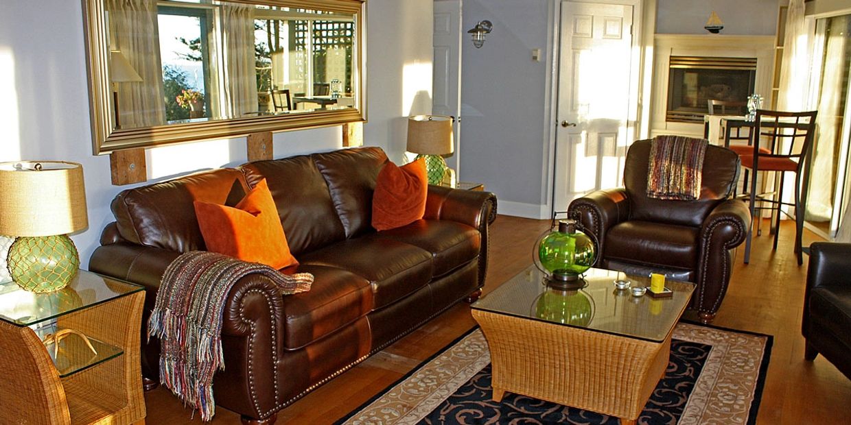 Cozy living room with leather furniture and warm accents.