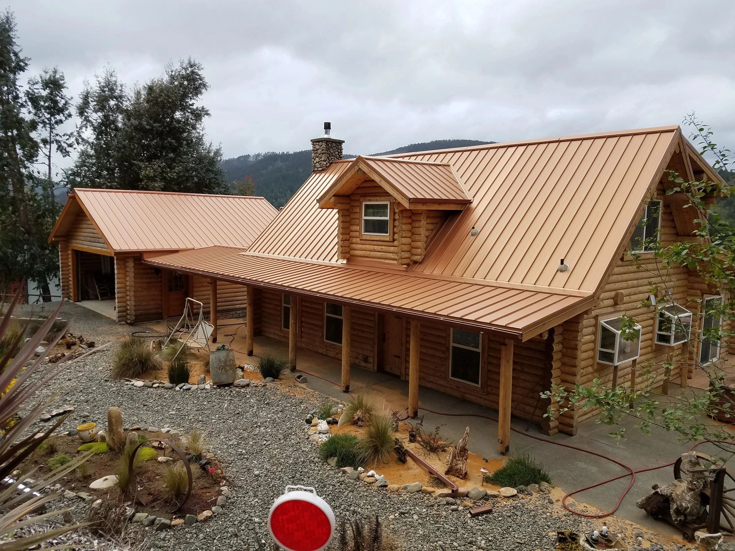 Log home refinished using Permachink systems 5-year warranty stain and chinking.