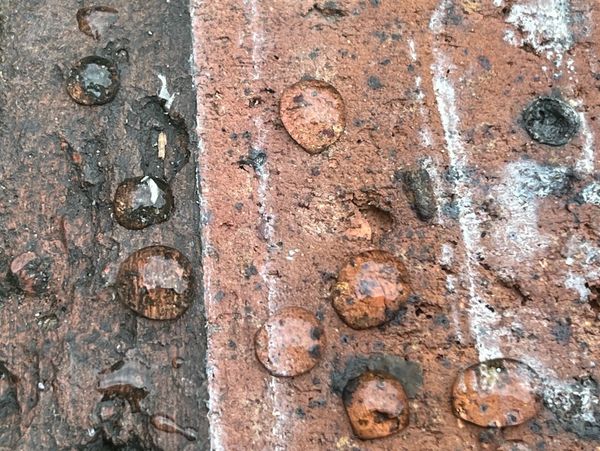 Red brick with drops of water on it