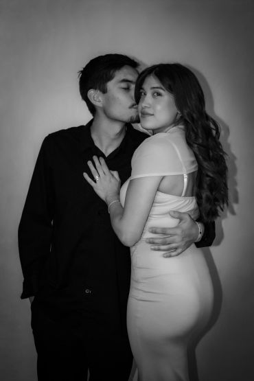 Couple sharing a tender moment in black and white.