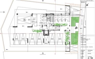 Architectural floor plan showing parking spaces, storage rooms, and green areas.
