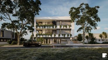 Modern three-story building with greenery and a black car in front.