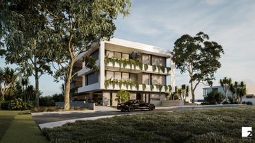 Modern three-story building with greenery and a black car parked outside.