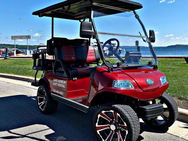red evolution golf cart with lake geneva in the background