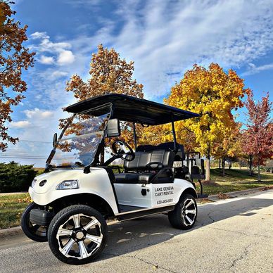 white evolution golf cart in front of trees