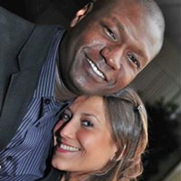 Happy couple smiling together in a close-up selfie.