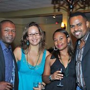 Four friends enjoying a night out at a social event.