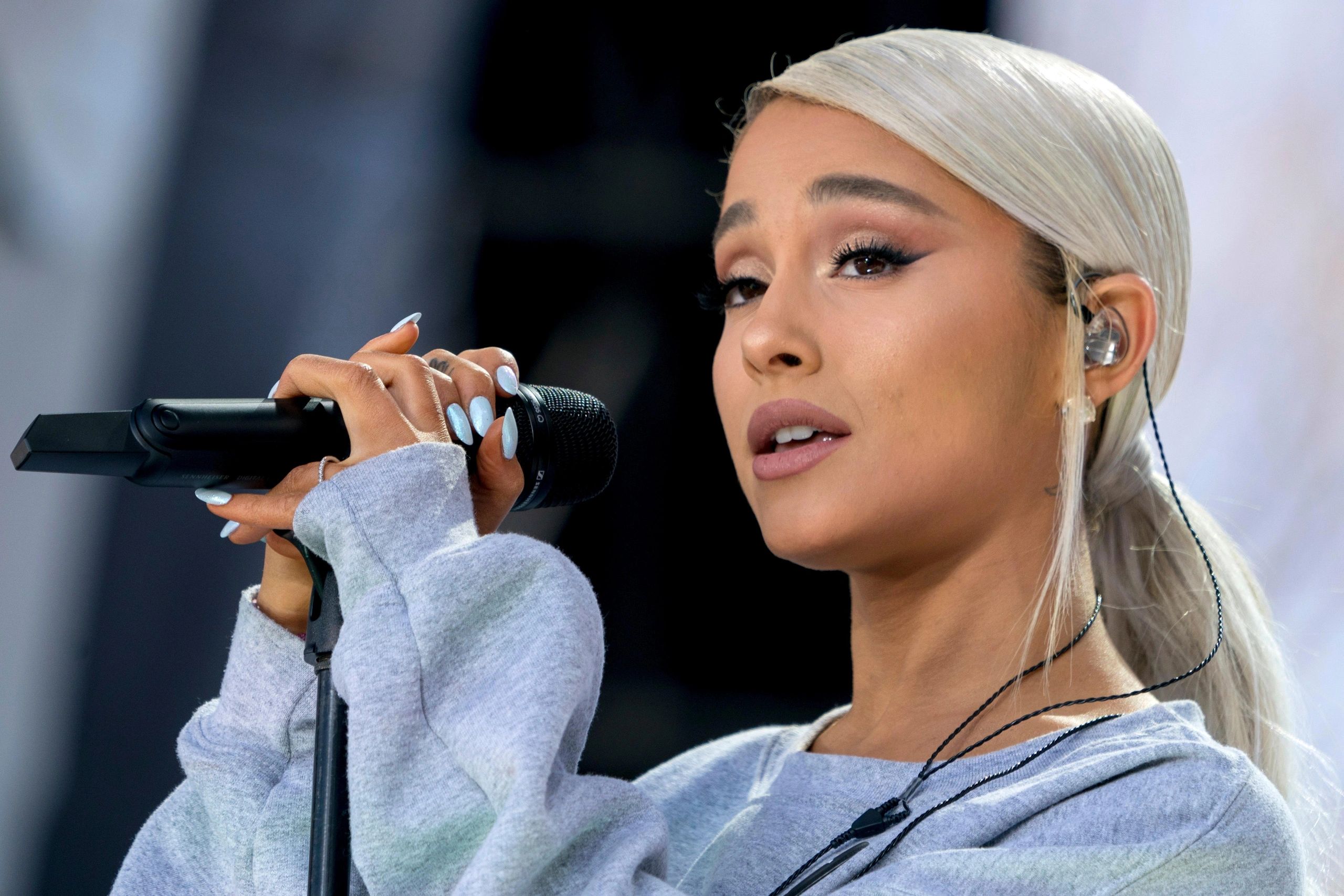 Ariana Grande performing wicked music with a microphone