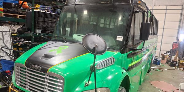 New green party 25 passanger party bus.