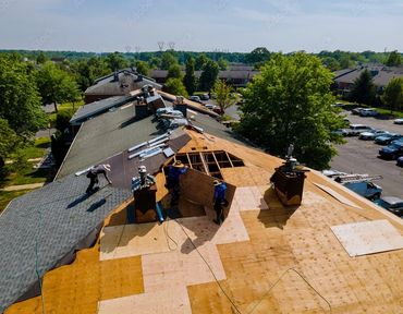 Men replacing entire roofing system.