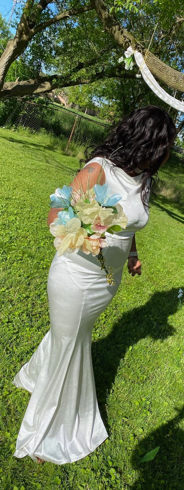 Ty looking at green trees and grass.