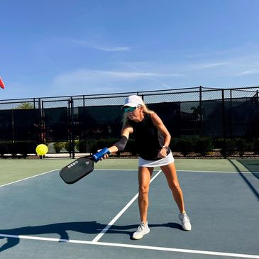 A pickleball player dinking at the non volley zone