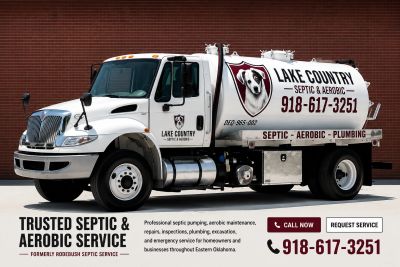 White septic service truck with company logo and contact information.