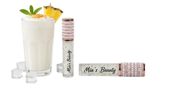 A creamy pineapple drink with ice cubes and Mia's Beauty lip gloss.