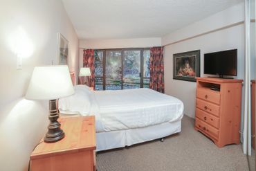 Master bedroom with a Queen bed, flatscreen TV.