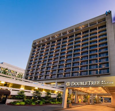 Exterior view of a DoubleTree by Hilton hotel building during dusk.