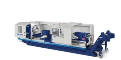 Large industrial lathe machine with control panel and chuck.