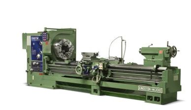 Large green industrial metal lathe machine used for precision machining.