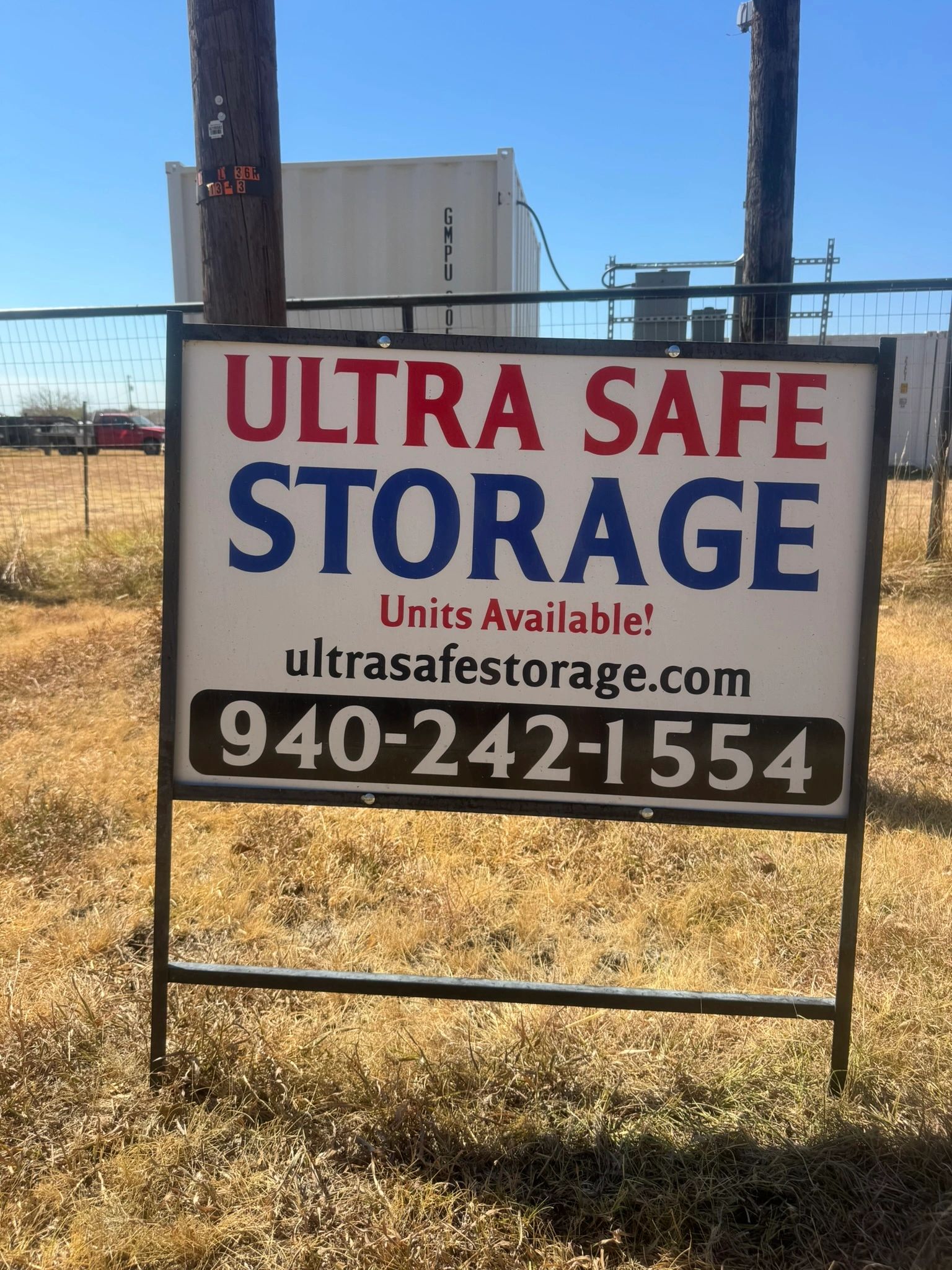 Ultra Safe Storage sign mounted on the fence at the Ponder, Texas yard, reading Units Available, ult