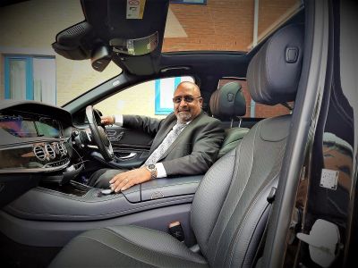 Professional Sahota Chauffeurs driver seated inside a Mercedes-Benz S-Class