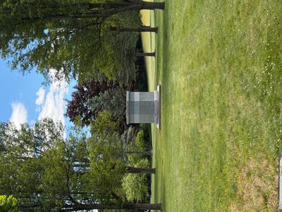 Memorial in a peaceful, green park with trees and grass.