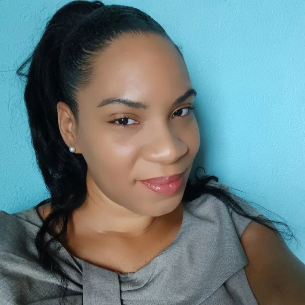 Stack of books next to pencils in a holder and a camera.