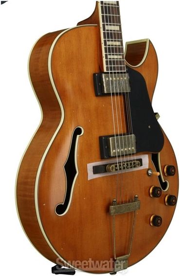 A classic brown hollow body electric guitar with dual pickups and control knobs.