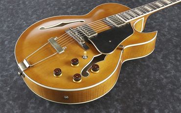 A classic hollow body electric guitar with a natural wood finish.