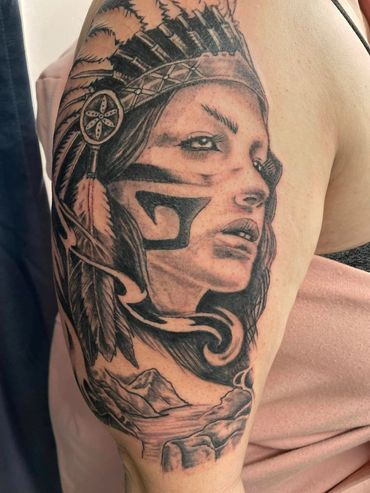 Black and grey tattoo of a Native American woman with face paint and headdress.