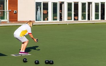 A woman bowling outdoors