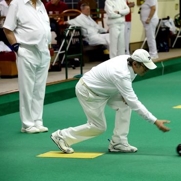 A man bowling indoors
