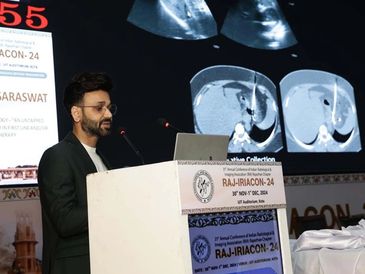 dr. Vrishit Saraswat presenting medical images at a conference podium.