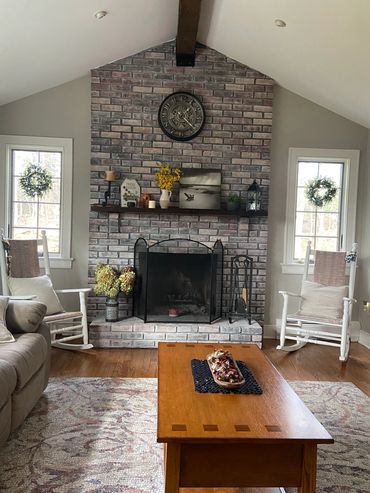 Fireplace with new casement windows installed and trimmed by Fraccaroli Carpentry