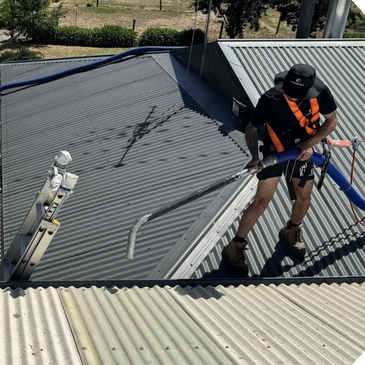 Peak Clean technician cleaning rooftop solar panels with specialised equipment to maximise efficienc