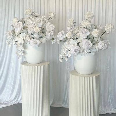 ripple plinths with vases and white real touch flowers with curtain draped straight down