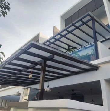 Modern house exterior with metal-framed glass balconies and pergola.