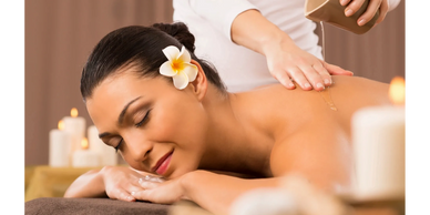 A person receiving a relaxing massage using a lotion blended with aromatic essential oils 