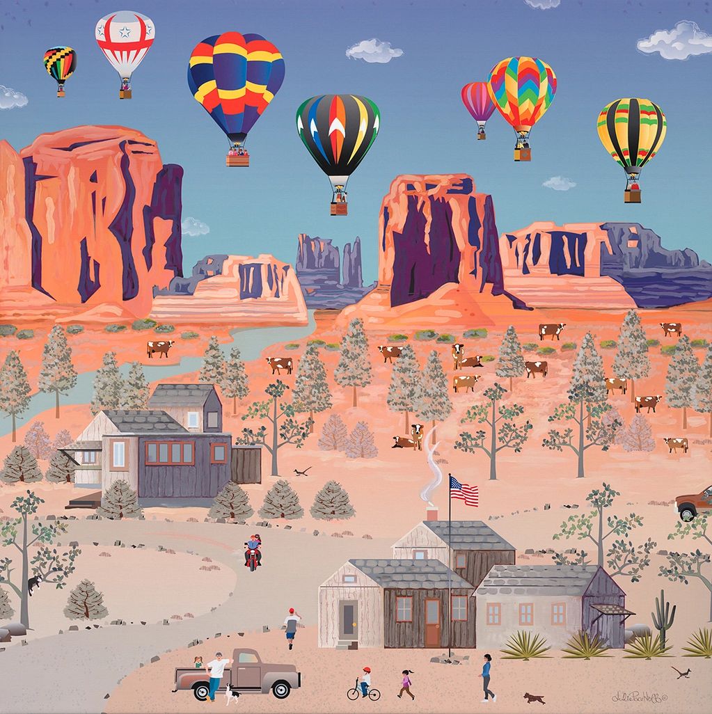 Hot air balloons over  a desert sandy town,