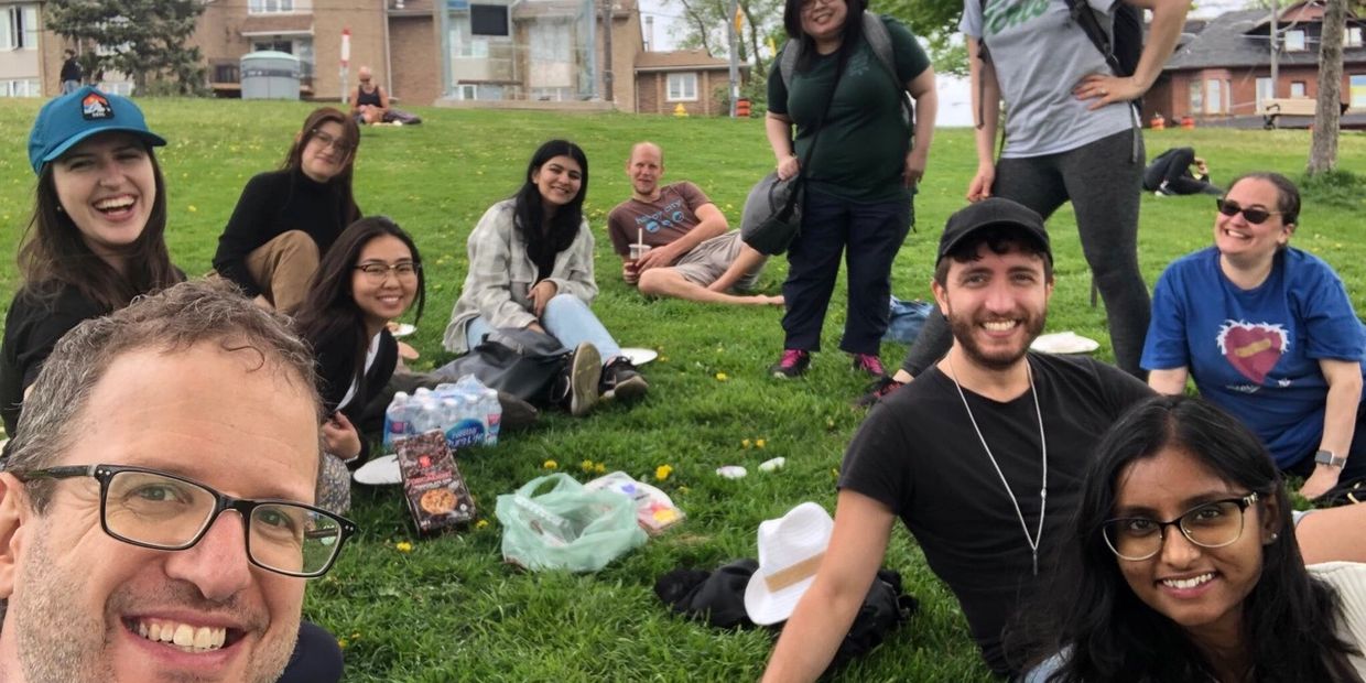 Group of people smiling at a picnic