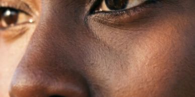 Close-up of a person's eyes and nose showing detailed skin texture.