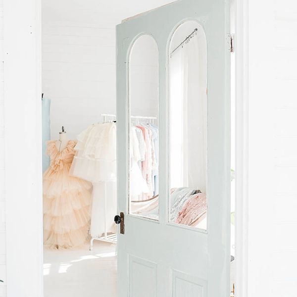mint color door to a room with dressers
