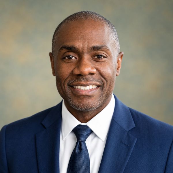 Confident man in a blue suit smiling.