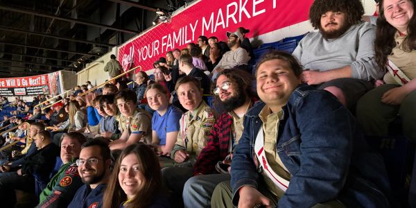 Group of people sitting together at an indoor event.