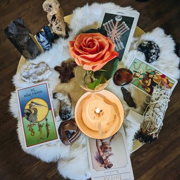 Sacred women’s circle altar with candles, flowers, and tea.